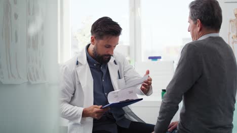 Handheld-view-of-doctor-looking-at-results-on-the-clipboard