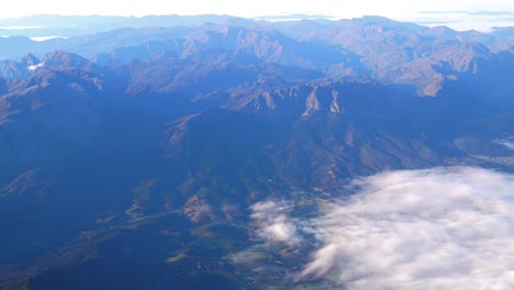 aerial view of top of mountains and flying above clouds