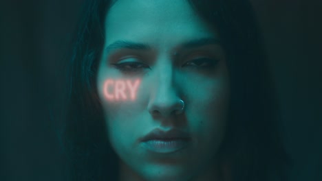 Woman with Neon 'Cry' Text on Face