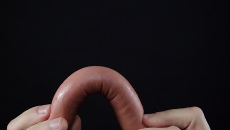 sausage being held in hands