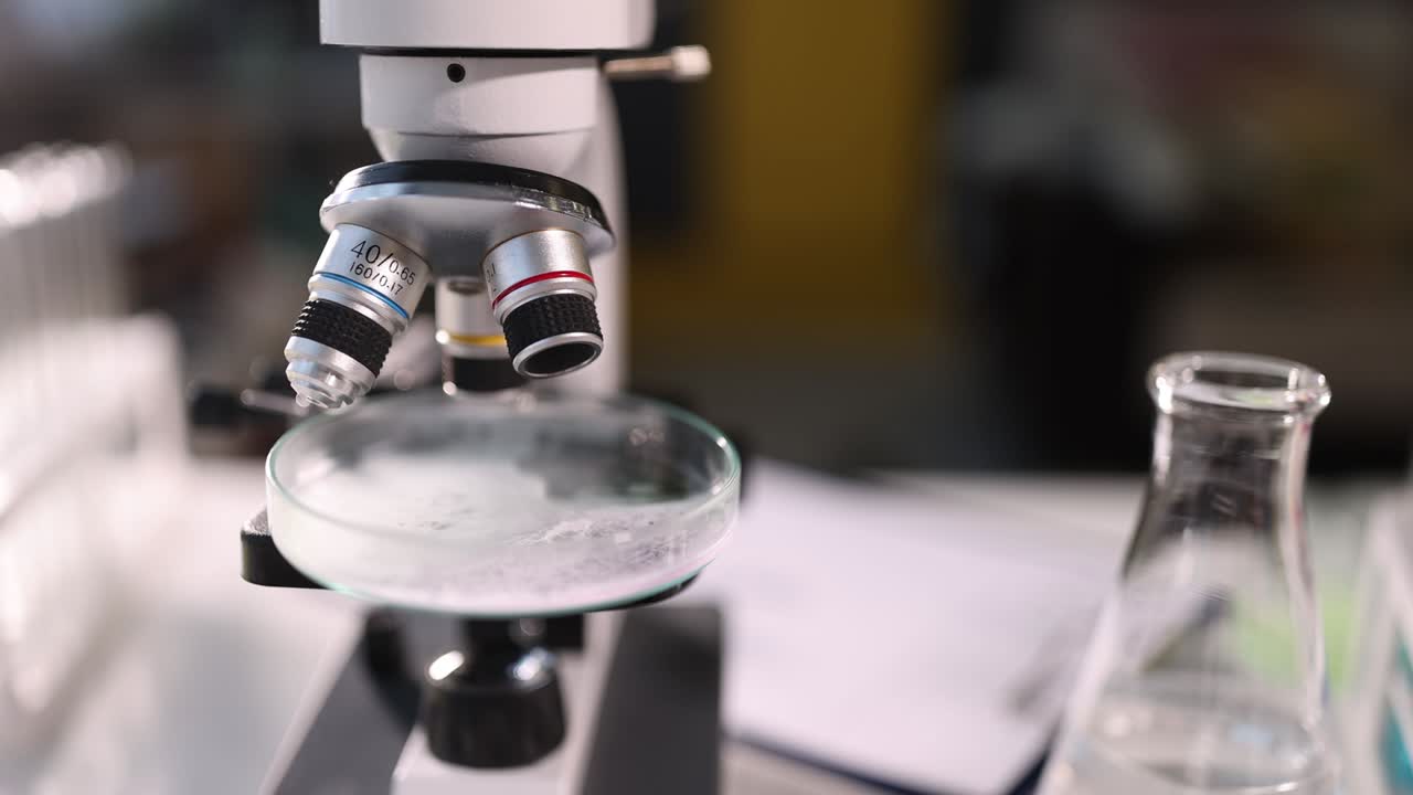 Microscope with petri dish in laboratory closeup