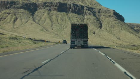 Vehicles-Driving-On-Road-With-View-Of-Rock-Formation-In-Arizona,-USA