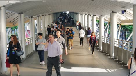 time lapse of many people going to their workplace in bangkok business area by using public mass transit system at chong-nonsi bts station in morning rush hour.