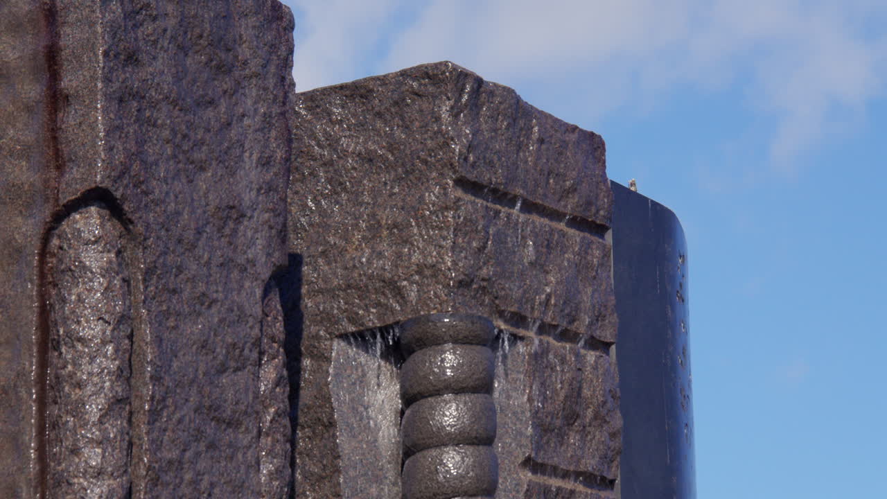 Close up shot of water running down the Nupen fontenen at Nupen parken, Kristiansand