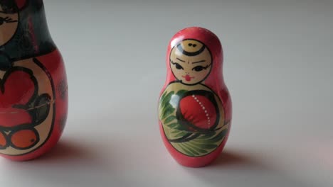 traditional russian matryoshka dolls arranged in a row, focusing on details of the painted designs