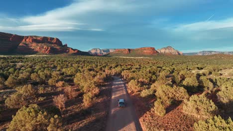 vehicle traveling on the scenic landscape of sedona arizona in united states - aerial drone shot