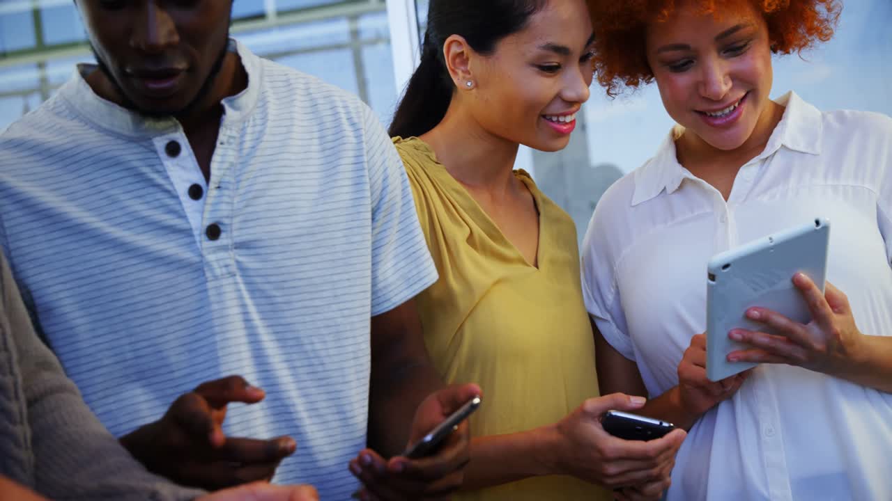 Executives discussing over digital tablet