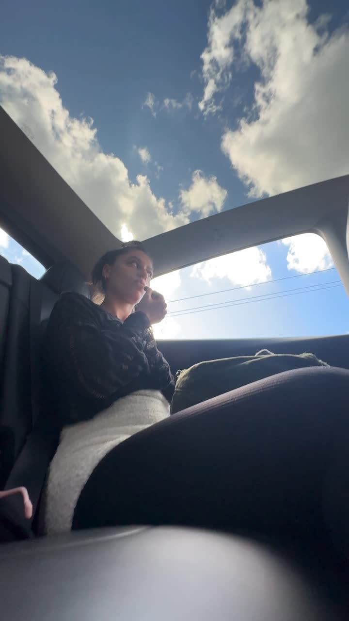 Woman in a car looking at the sky