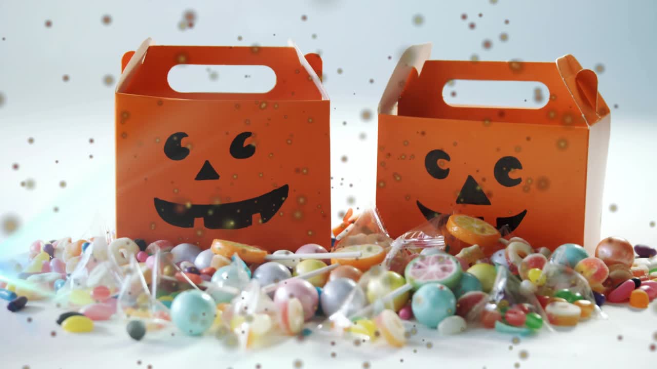 Golden sparkles drifting surrounding pumpkin box as second box entering showcasing candies