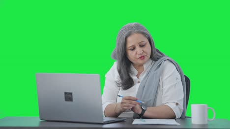 Happy-Indian-senior-female-manager-doing-meeting-on-video-call-Green-screen