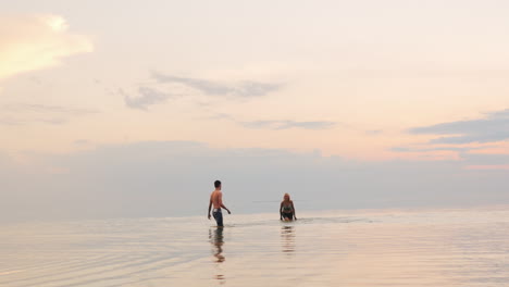 man and woman playing in water - splash each other with worm water