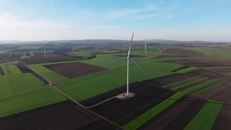 Wind-turbines-on-lush-green-fields-on-a-sunny-day