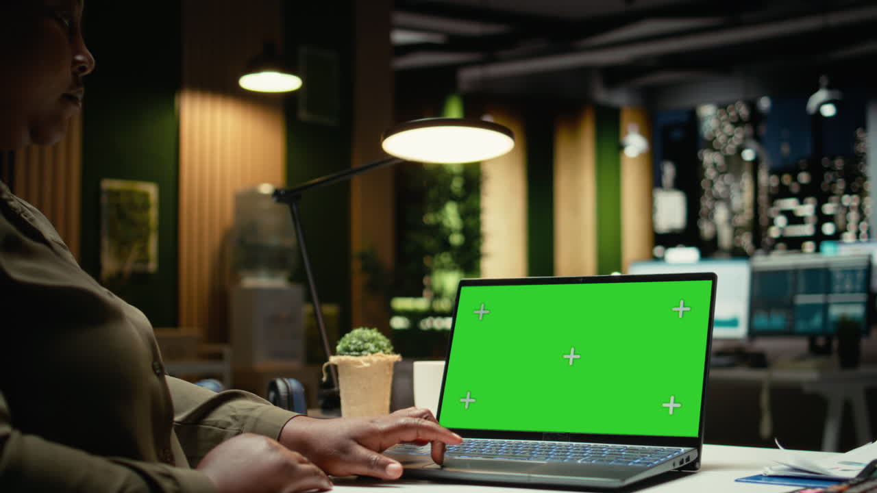 Chroma key display on laptop with black woman manager solving management