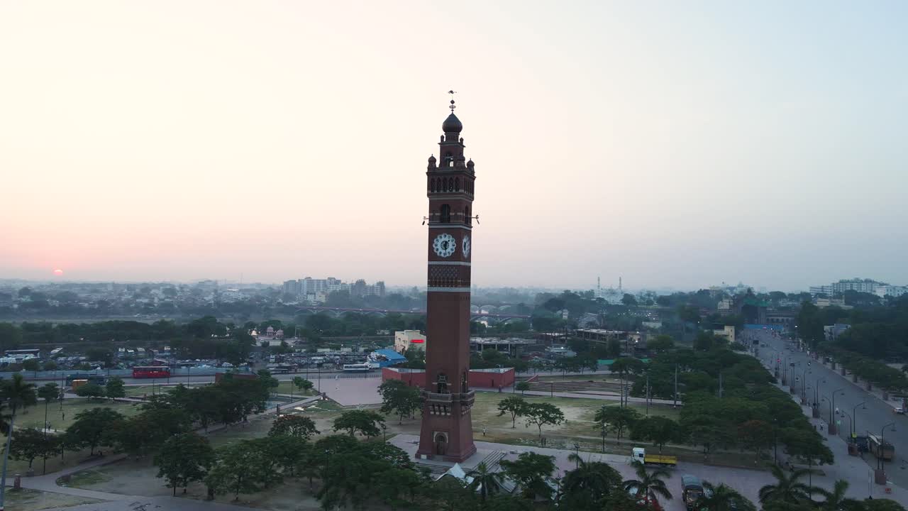 aerial drone shot of Lucknow's Clock Tower at sunrise, with soft golden light casting over the city.