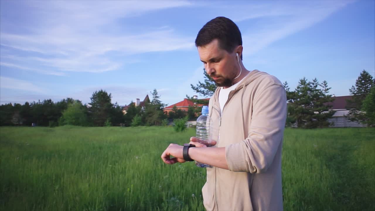 Man Checking Fitness Watch Outdoors