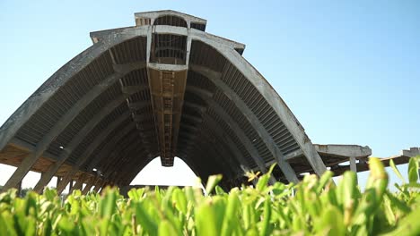 large abandoned concrete building is deteriorating, releasing toxic particles into the atmosphere