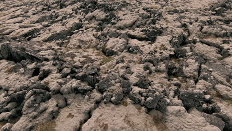 slow closeup above lava fields covered in moss