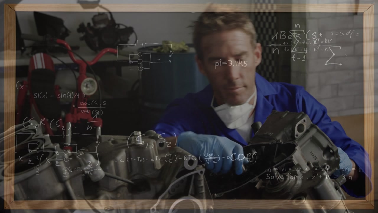 A caucasian male mechanic is repairing motorbike parts in a repair garage