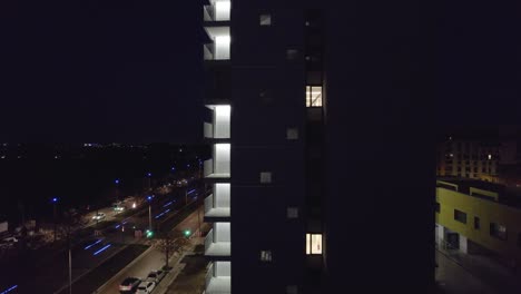 Aerial-view-of-modern-architecture-building-at-night-with-vibrant-terrace