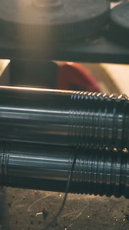 cu: jeweler craftsman forge-rolls white gold wire with machine tool at workplace in jewelry workshop close view