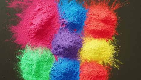 video of multi coloured powders with copy space on black background