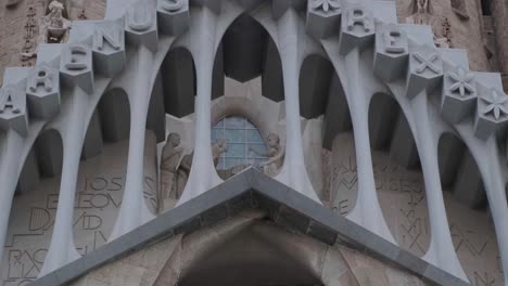 Detalles-De-La-Fachada-De-La-Pasión-De-La-Sagrada-Familia-Y-Crucifixión-De-Cerca-Inclinada-Hacia-Abajo-4k-25fps