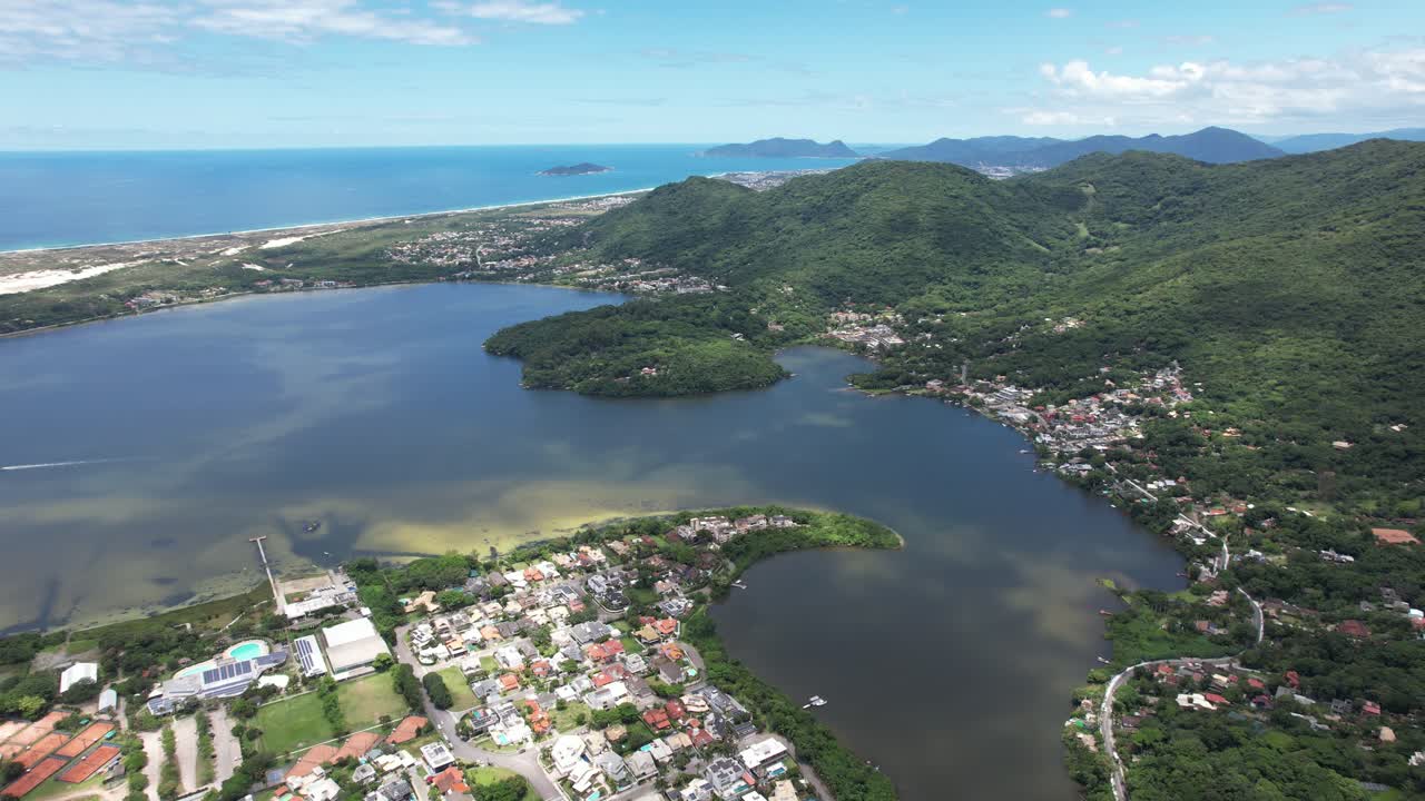 panoramic drone showing the beautiful aerial view and landscape on the island of santa catarina, south of brazil, magical light, few clouds and blue sky