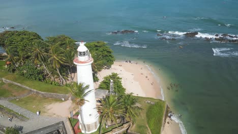 aerial circular shot over the white lighthouse of galle dutch fort