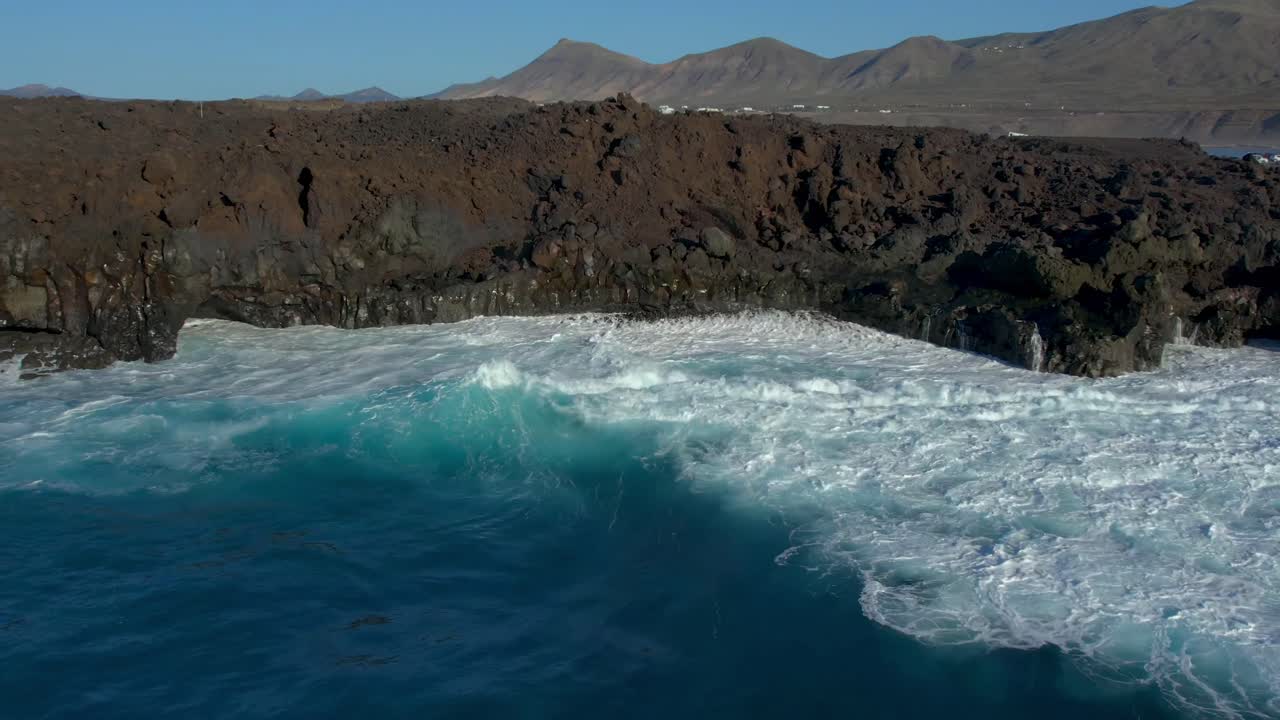 Aerial drone view of mountain sea and volcanoes in Lanzarote, Canary Islands, Spain