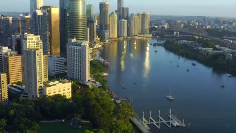 revealing aerial view of brisbane city cbd highrise buildings with glowing morning light, qld, australia