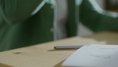 person working at a desk with coffee and drawings