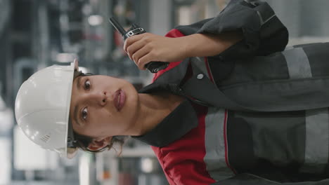 portrait of female factory worker with radio