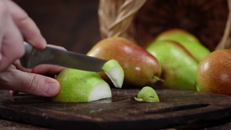 hands men of ripe pear sliced to pieces.