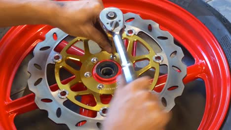 Close-up-Footage-of-Mechanic-Working-On-Disc-Brake-Installation-For-Motorcycle