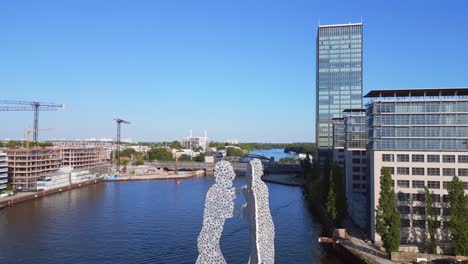 skyscraper dramatic aerial top view flight molecule man on border river spree, east berlin germany evening summer 23