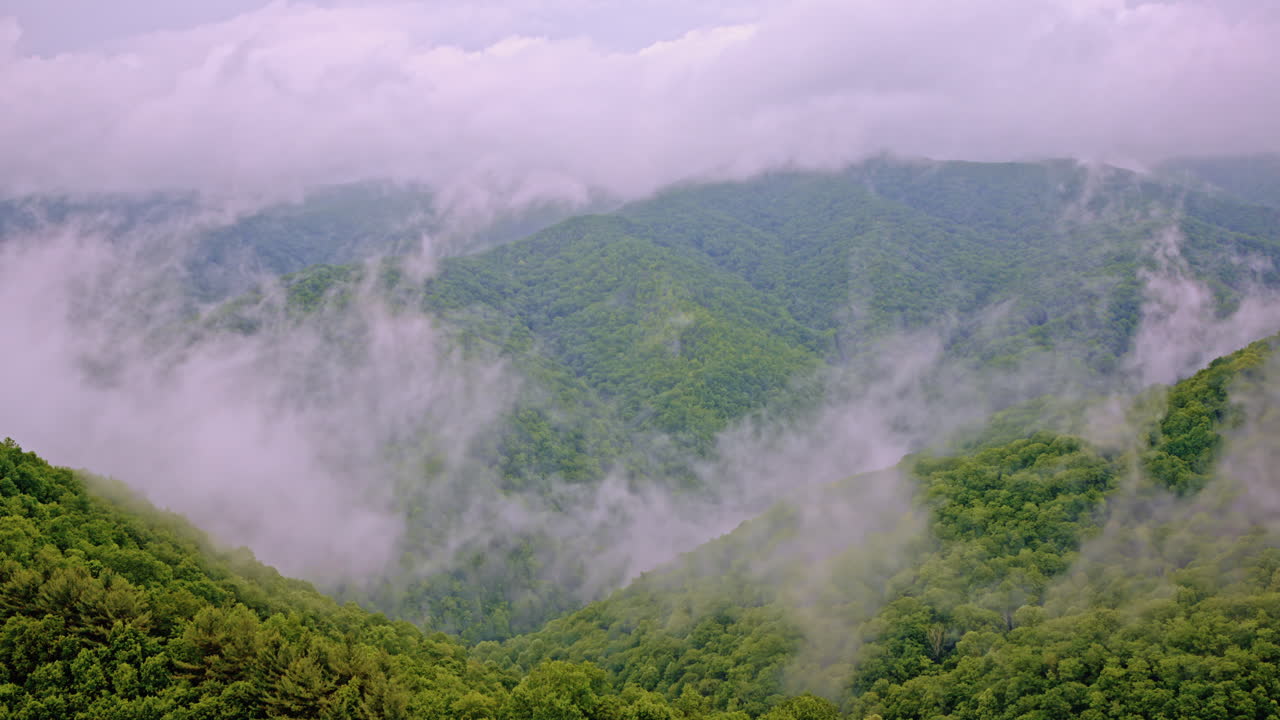 Cinematic drone shot of the great smoky mountains full of mist and fog