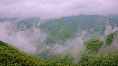 cinematic drone shot of the great smoky mountains full of mist and fog