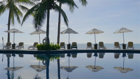 outdoor swimming pool with umbrella and chair in hotel resort
