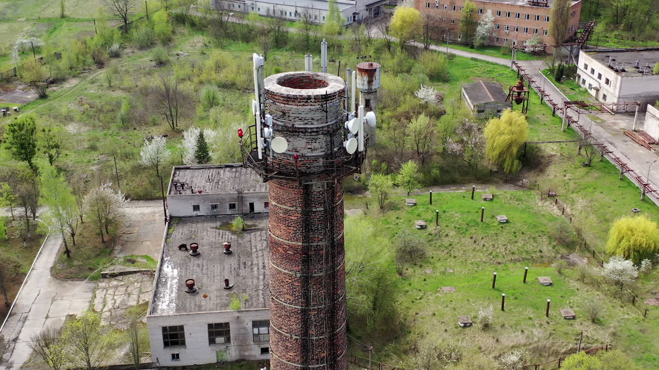 Aerial view of abandoned ruined factory tube. Apocalypsis crashed city.
