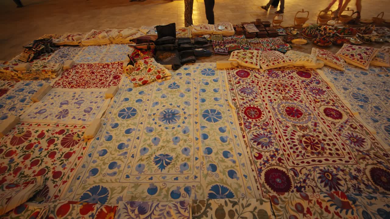 Khiva merchant embroidered fabric, old city. Uzbekistan silk road at night