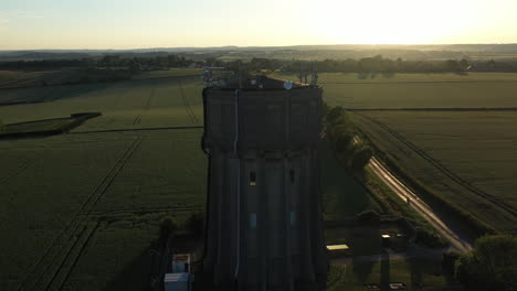 Aerial-footage-of-a-water-tower-on-a-summers-evening