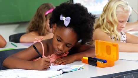 school kids doing homework in classroom