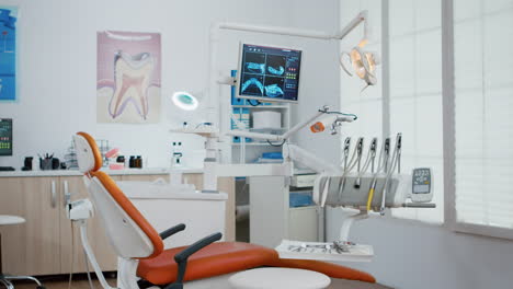 interior of modern equipment oral office with teeth x ray on monitors