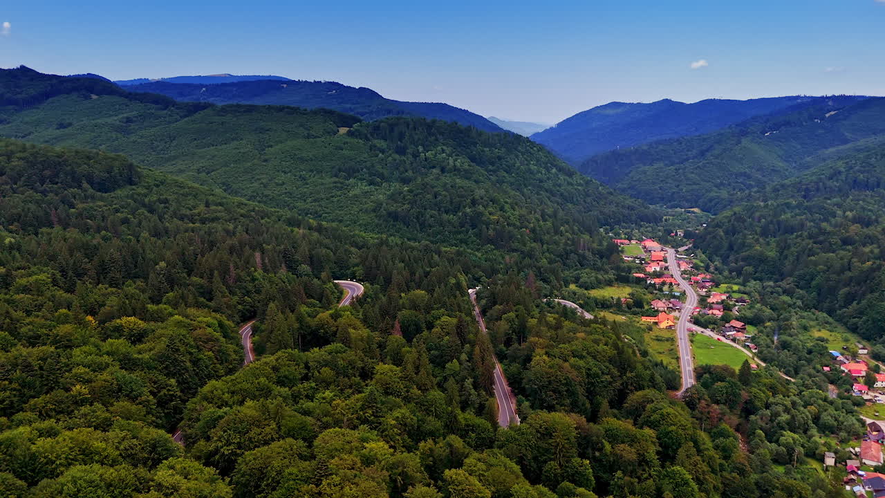 Winding roads in mountains. Lush greenery and winding roads connect charming villages amidst stunning mountains and valleys