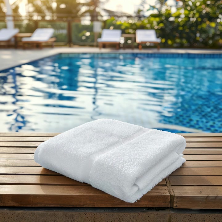 Fresh White Towel on Poolside Deck at a Luxury Resort