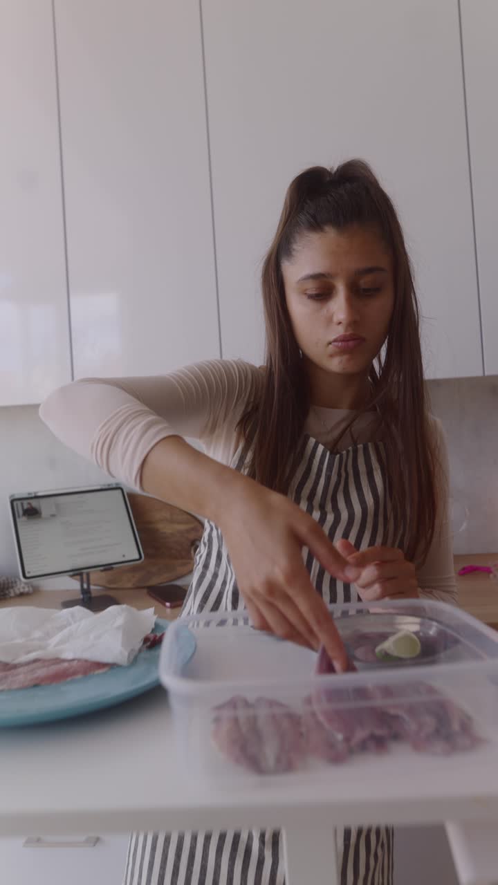 Woman Preparing Fish in Kitchen