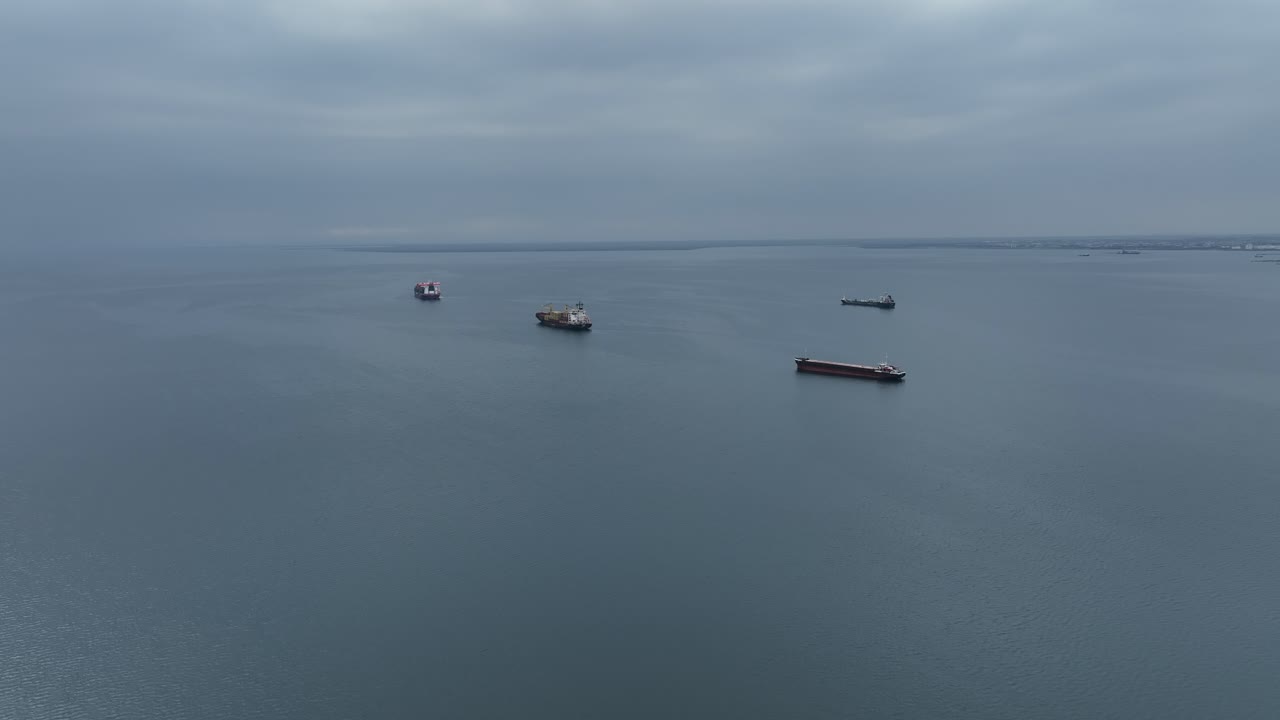 Large container ships in the Thermaic Gulf maneuvering to unload cargo at the port of Thessaloniki, Greece.