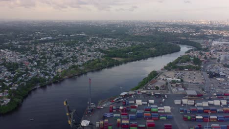 channel of haina commercial port with city in background