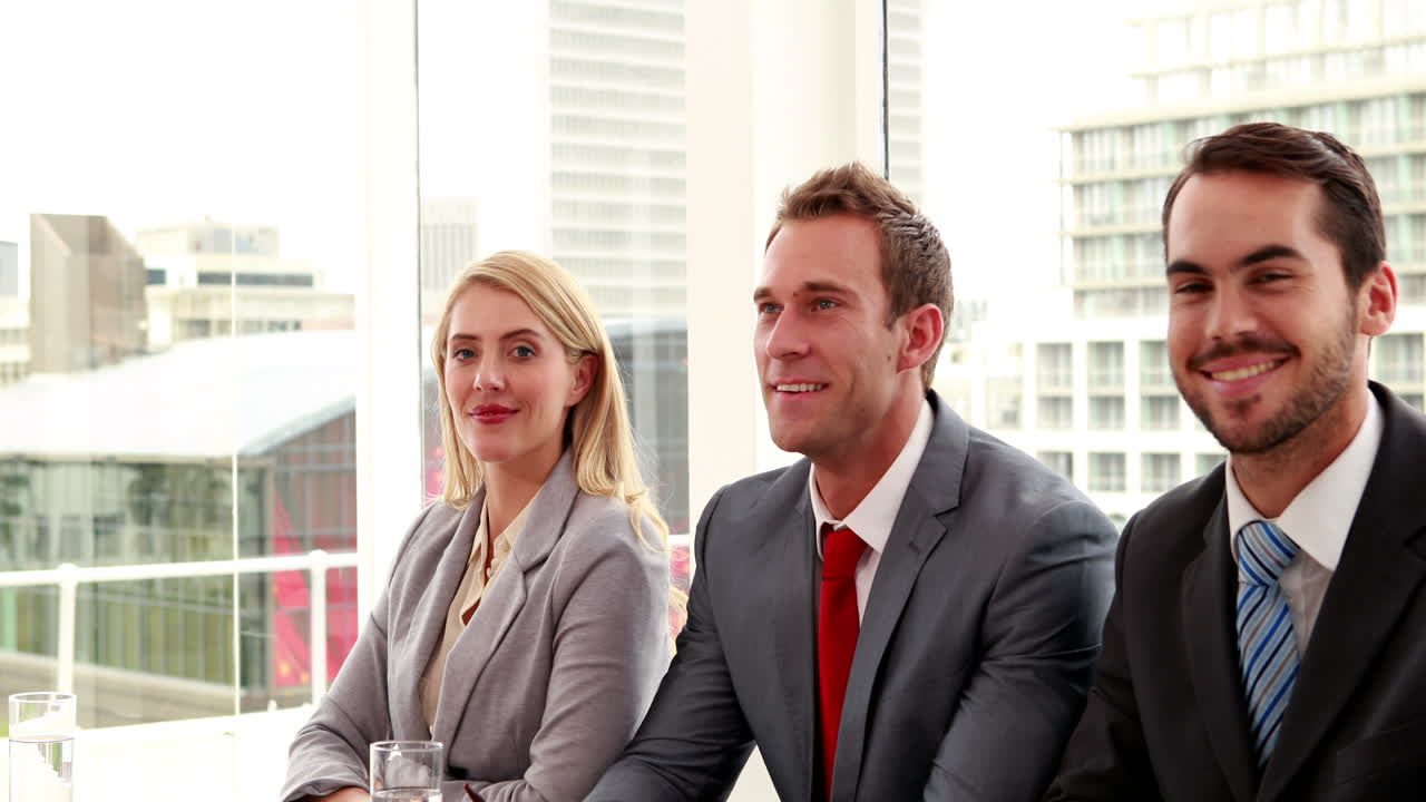 Interview panel shaking hands with applicant