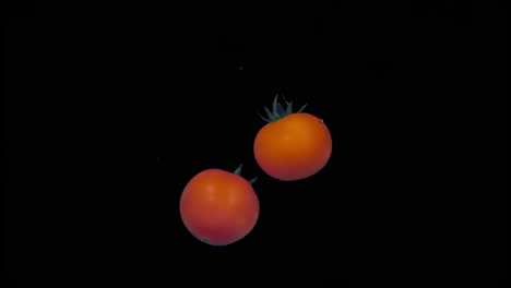 two tomatoes underwater